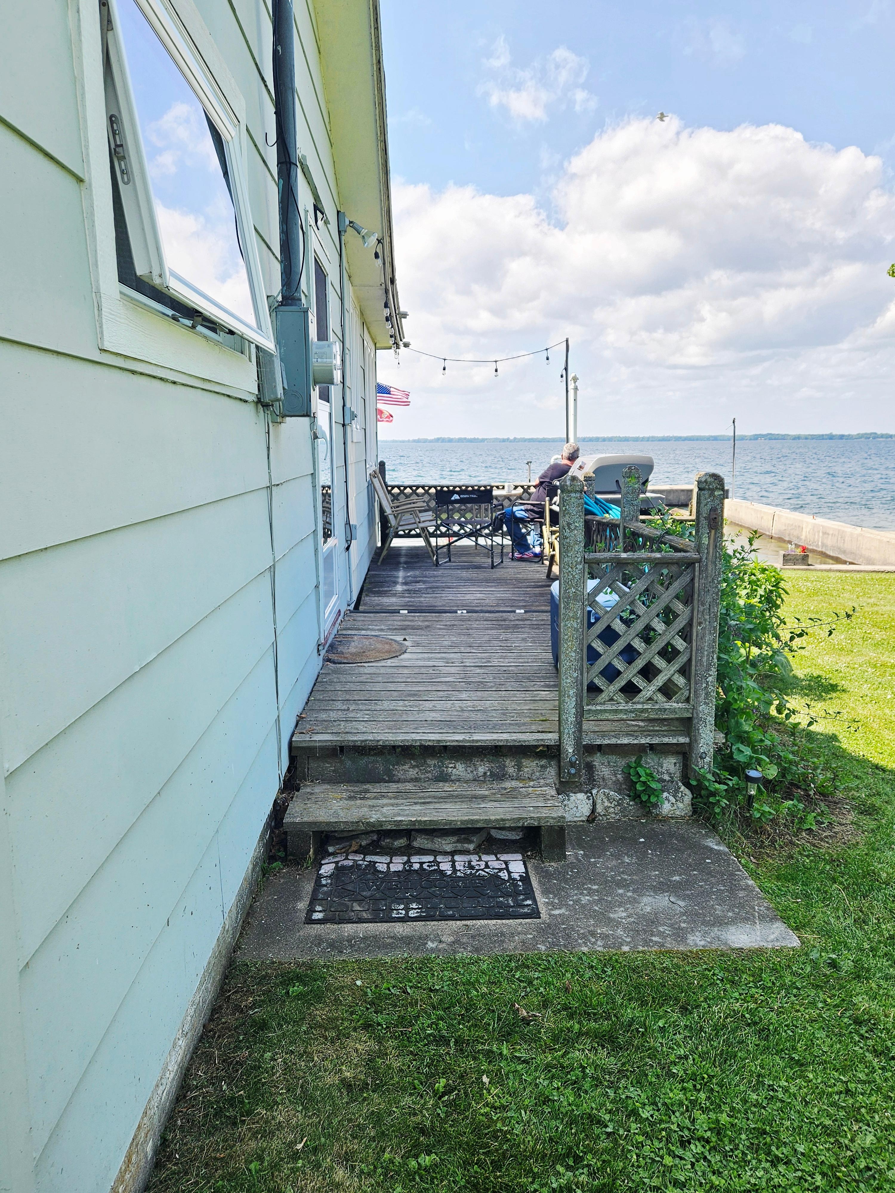 Cute little side porch which breaks the wind for sitting outside.