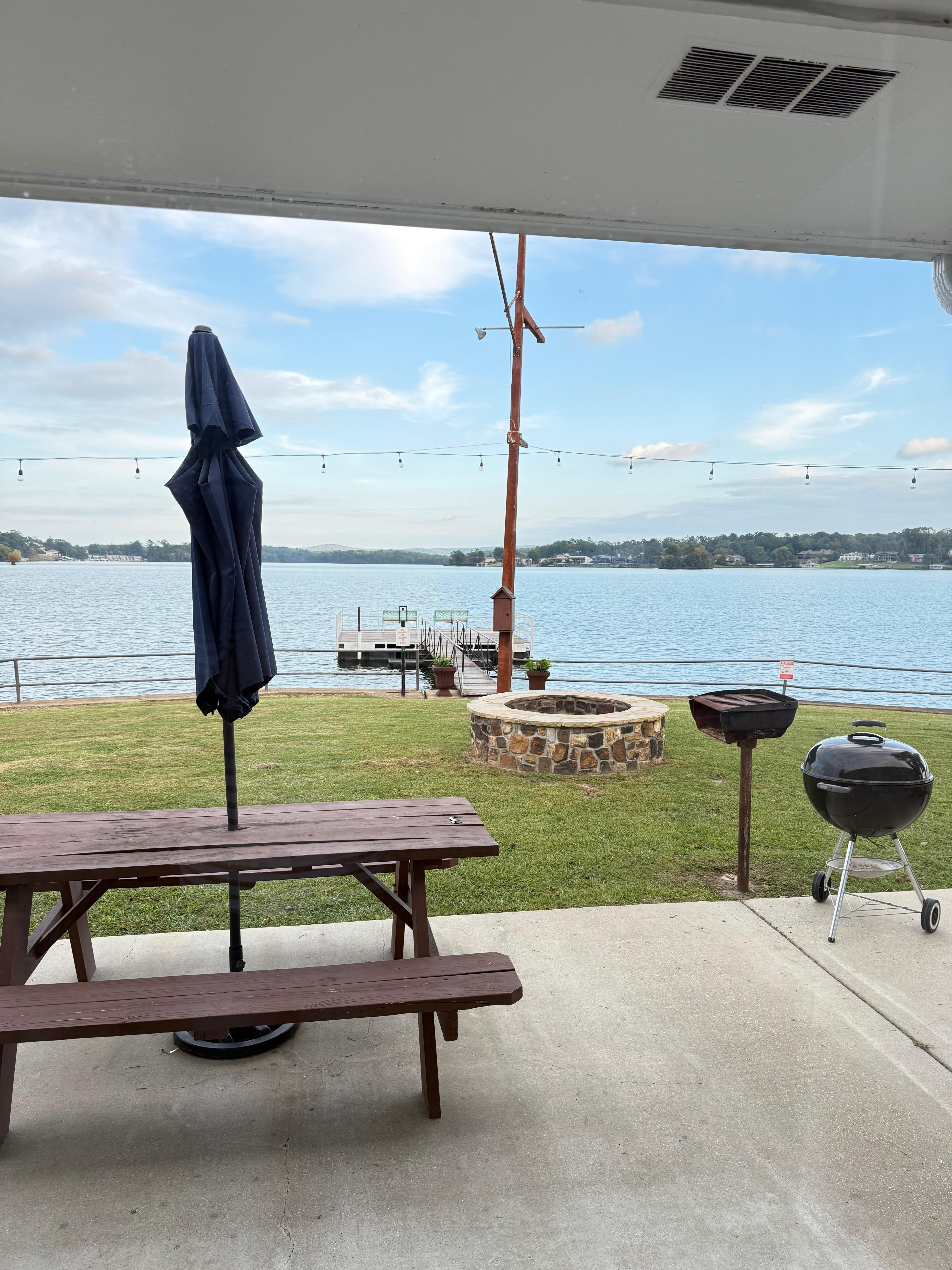 Picnic table, fire pit, grill, and dock outside the room. 