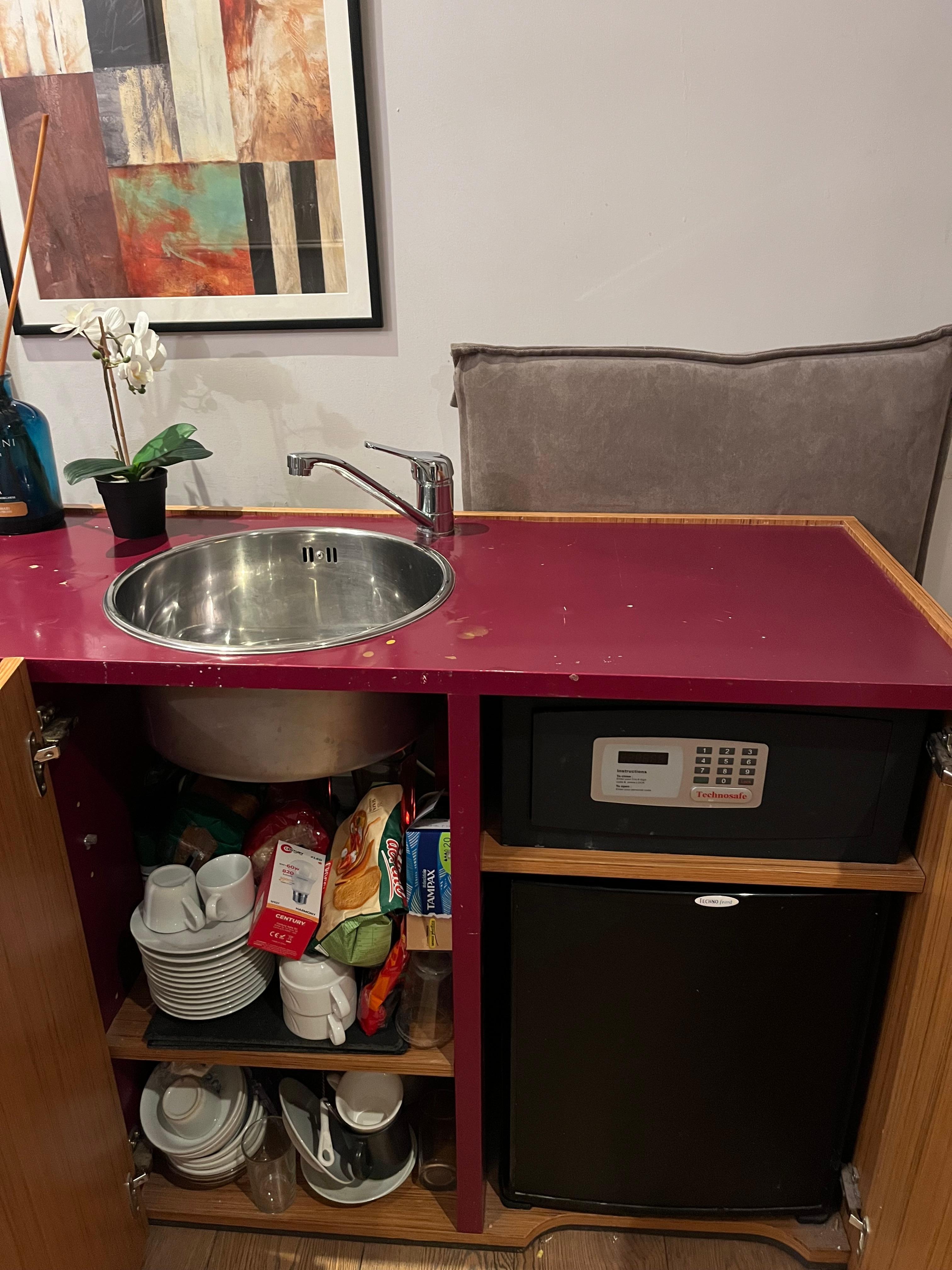 Cupboards loaded with messy stuff (many more extra items are stored in the room)