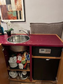 Cupboards loaded with messy stuff (many more extra items are stored in the room)