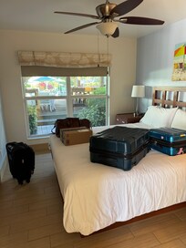 Common area sidewalk and seating within feet of bed.