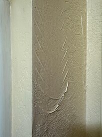 Popped paint bubble. Evidently water was under the paint as some point.