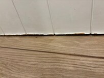 Door to bathroom that shows water damage.