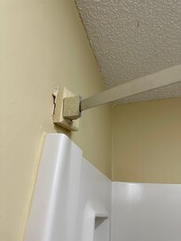 The rod was drilled into pieces of wood and not even attached directly to the wall