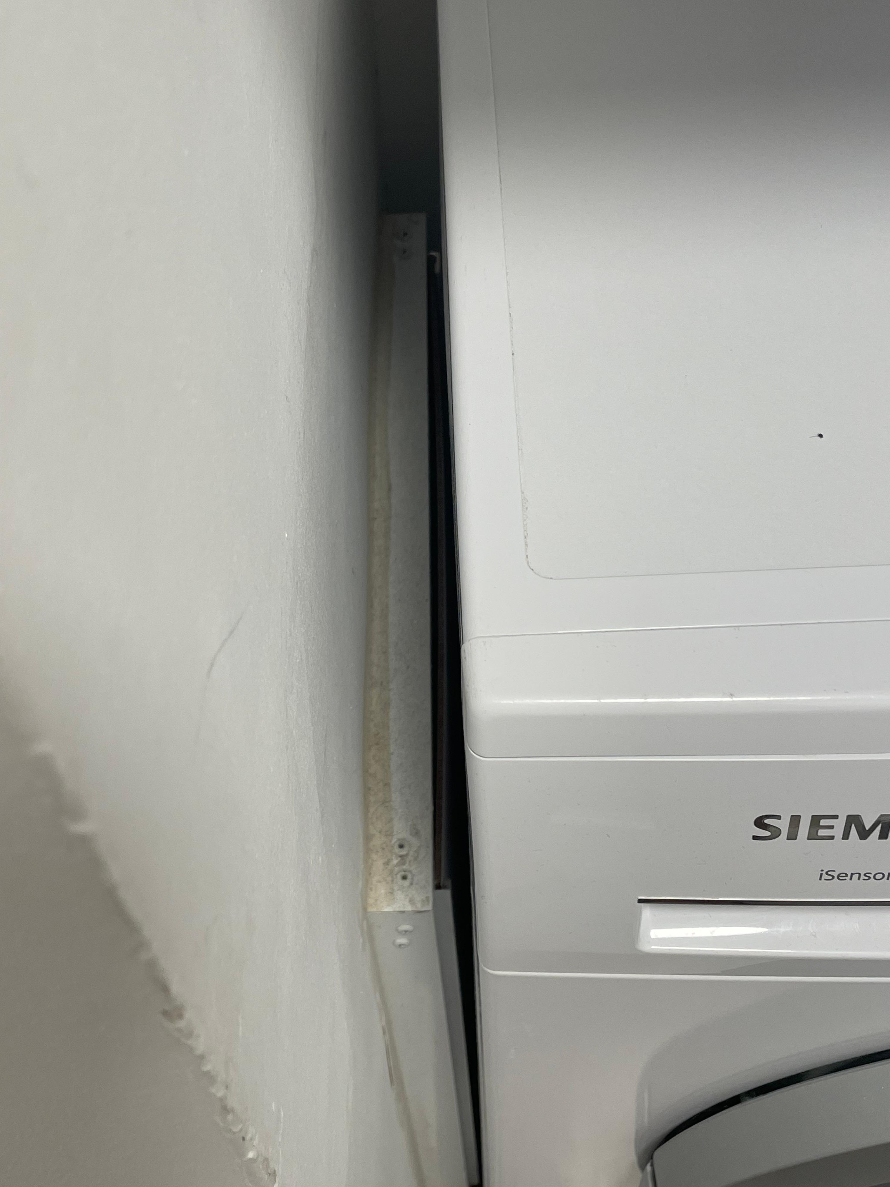Dirt and dust along the side of the washer 