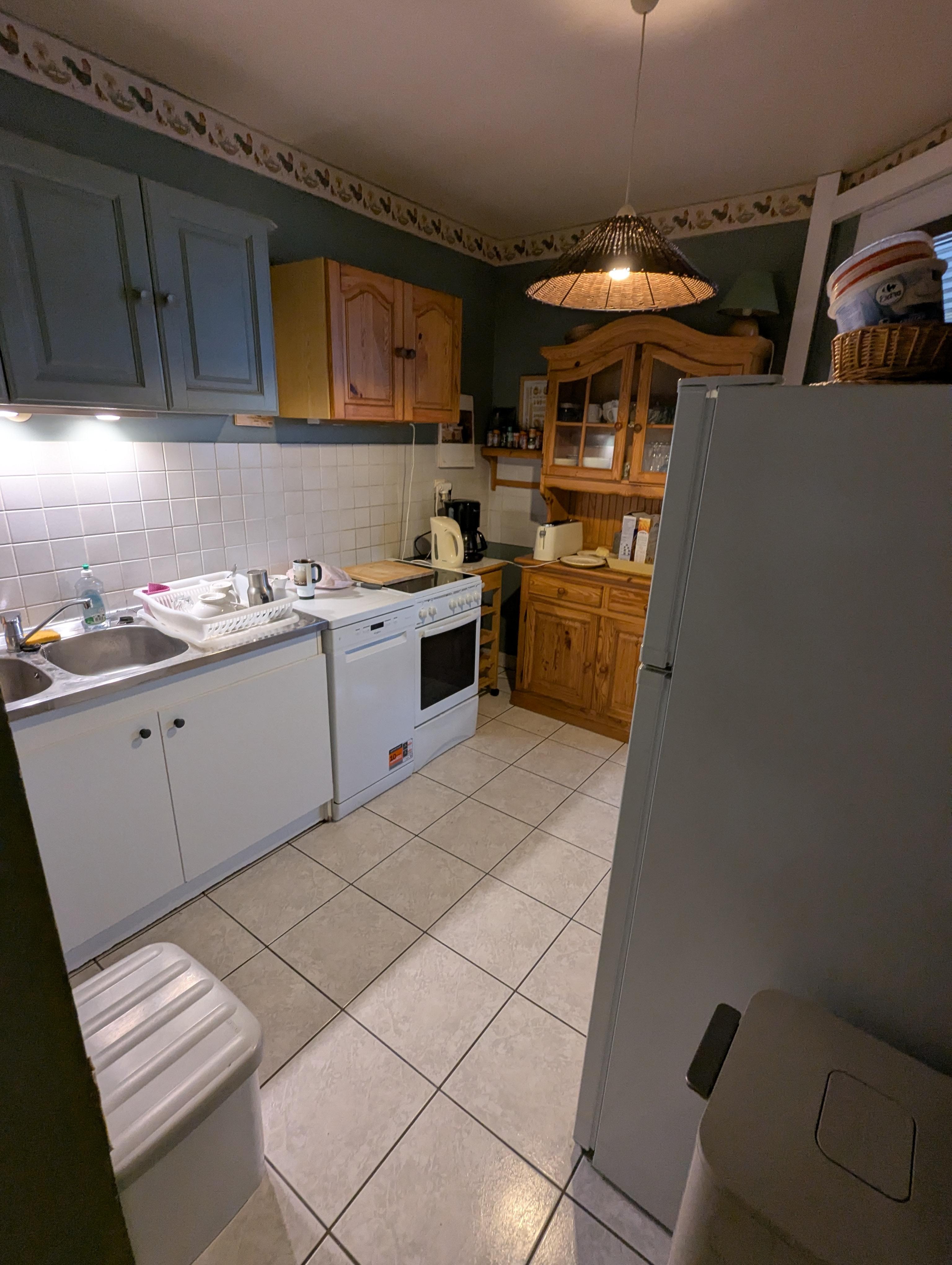 Kitchen -- there's a full sized refrigerator, a range, a microwave, two basin sink, and plenty of utensils, glasses, plates, and pots and pans.