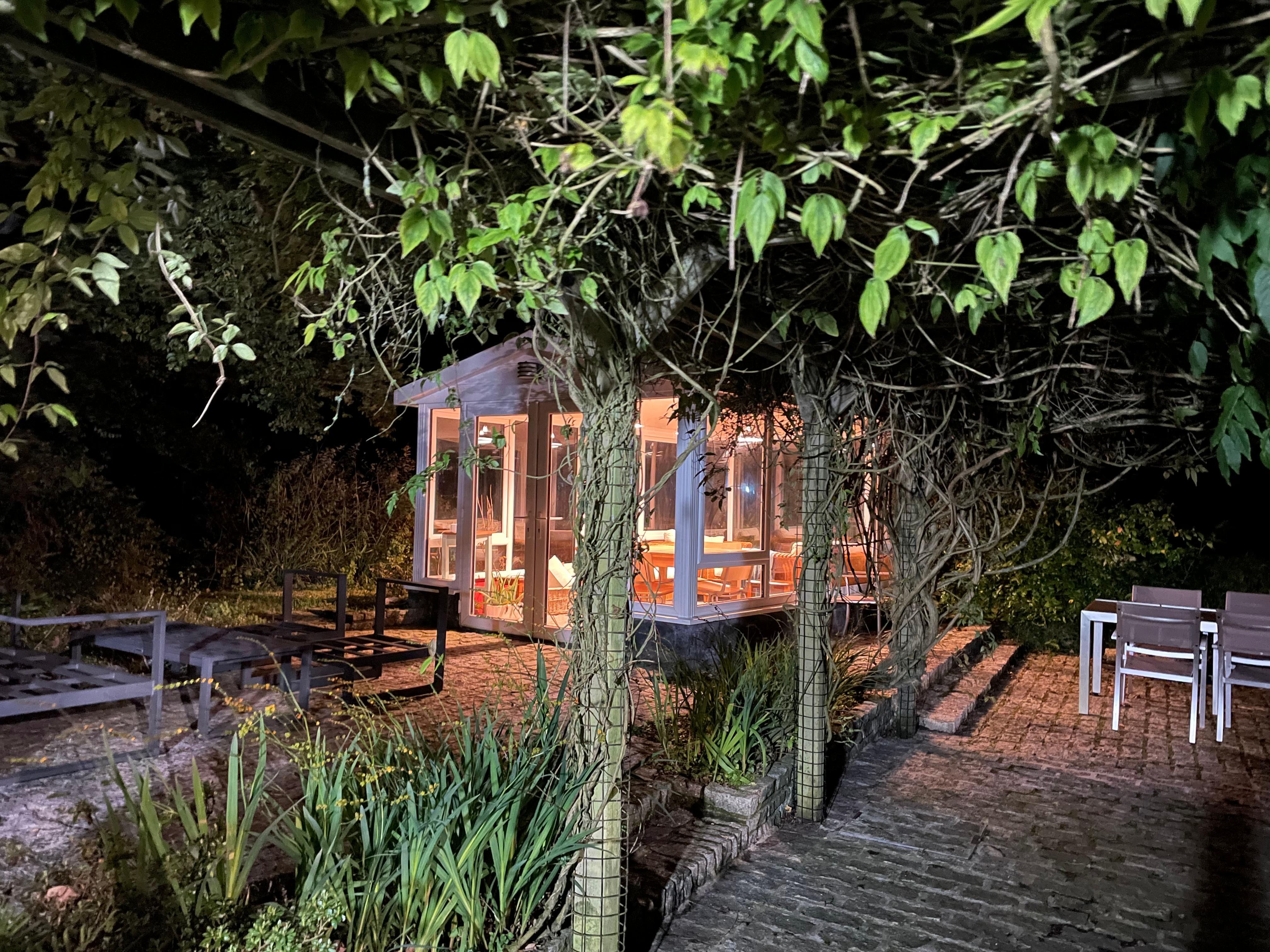 Summerhouse lit up at night 