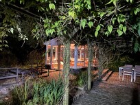 Summerhouse lit up at night