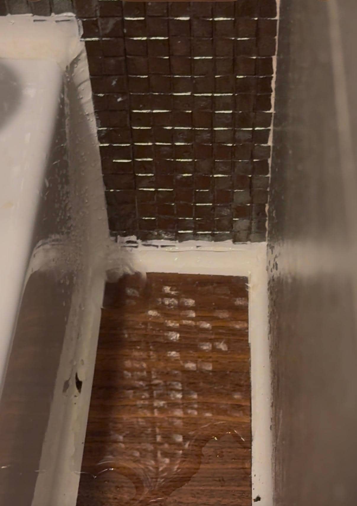 Water dripping from the bathroom ceiling onto the vanity 