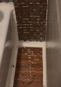 Water dripping from the bathroom ceiling onto the vanity