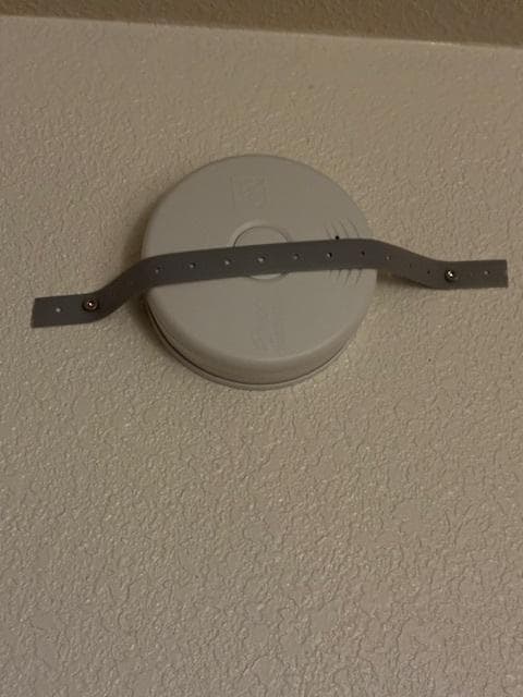 Smoke detector metal
strapped to the wall