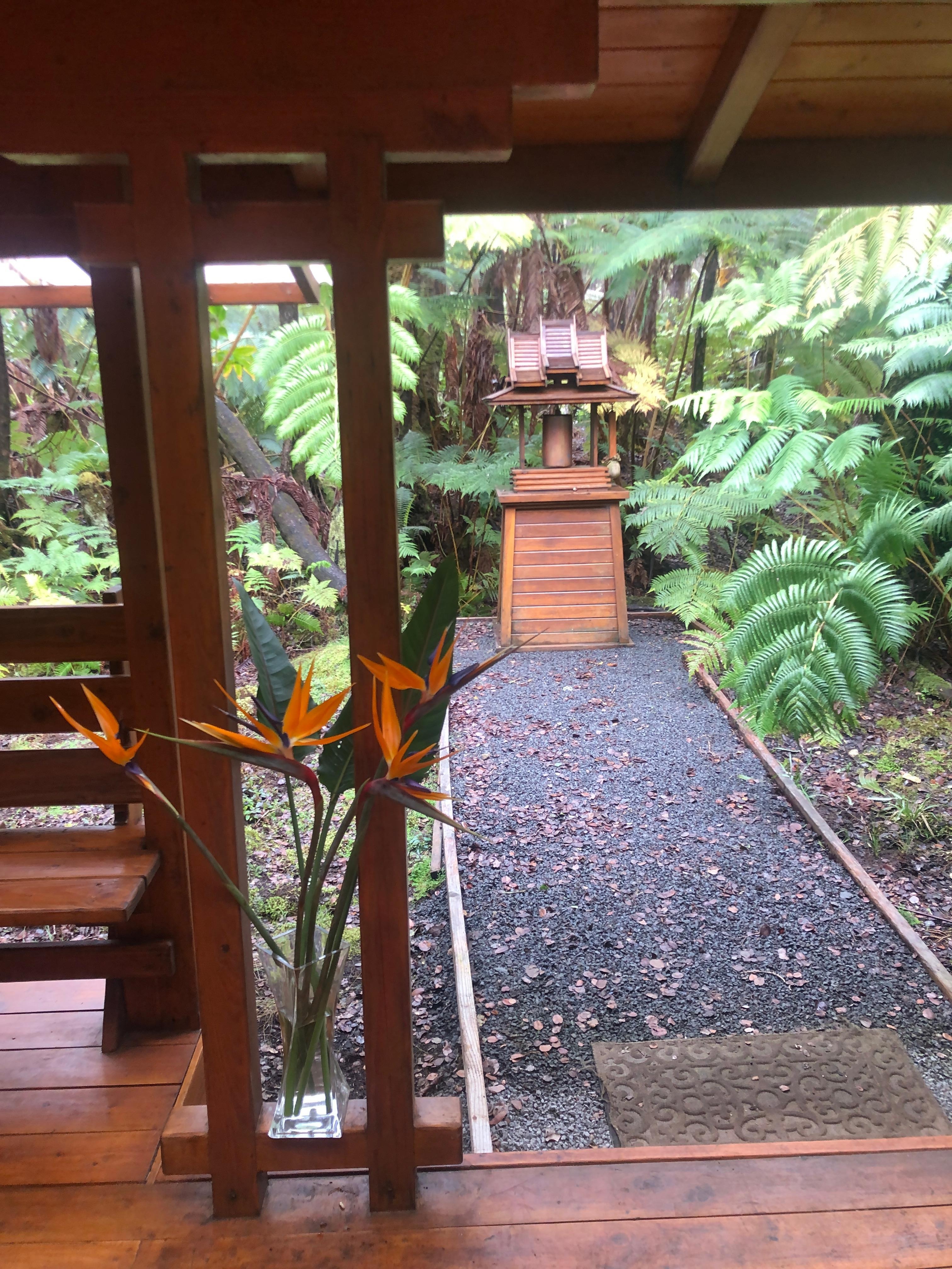 Beautiful tropical flowers at the doorway with a homemade gong in the distance was a nice touch to end my daily yoga! 