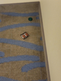 In the corner of the room to which the cleaning staff missed.