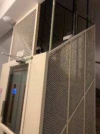 One very small lift max 2 people servicing 6 floors