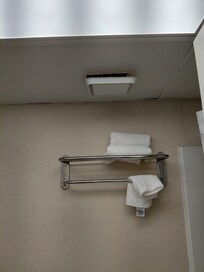Not connected vent in the ceiling of the bathroom.