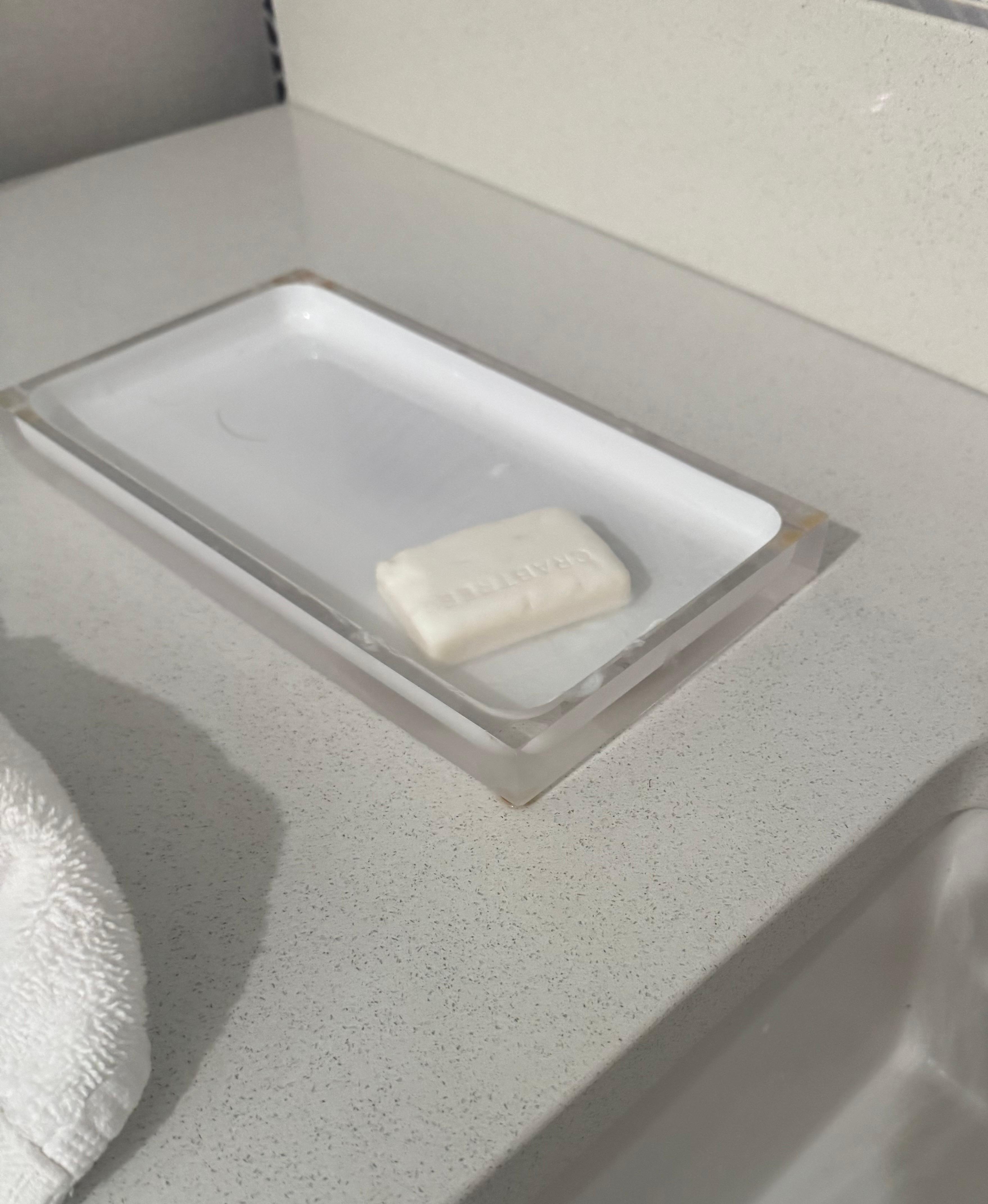 On counter is only bar of soap and shower cap 