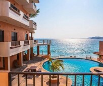 Beautiful pool area with lots of seating overlooking ocean