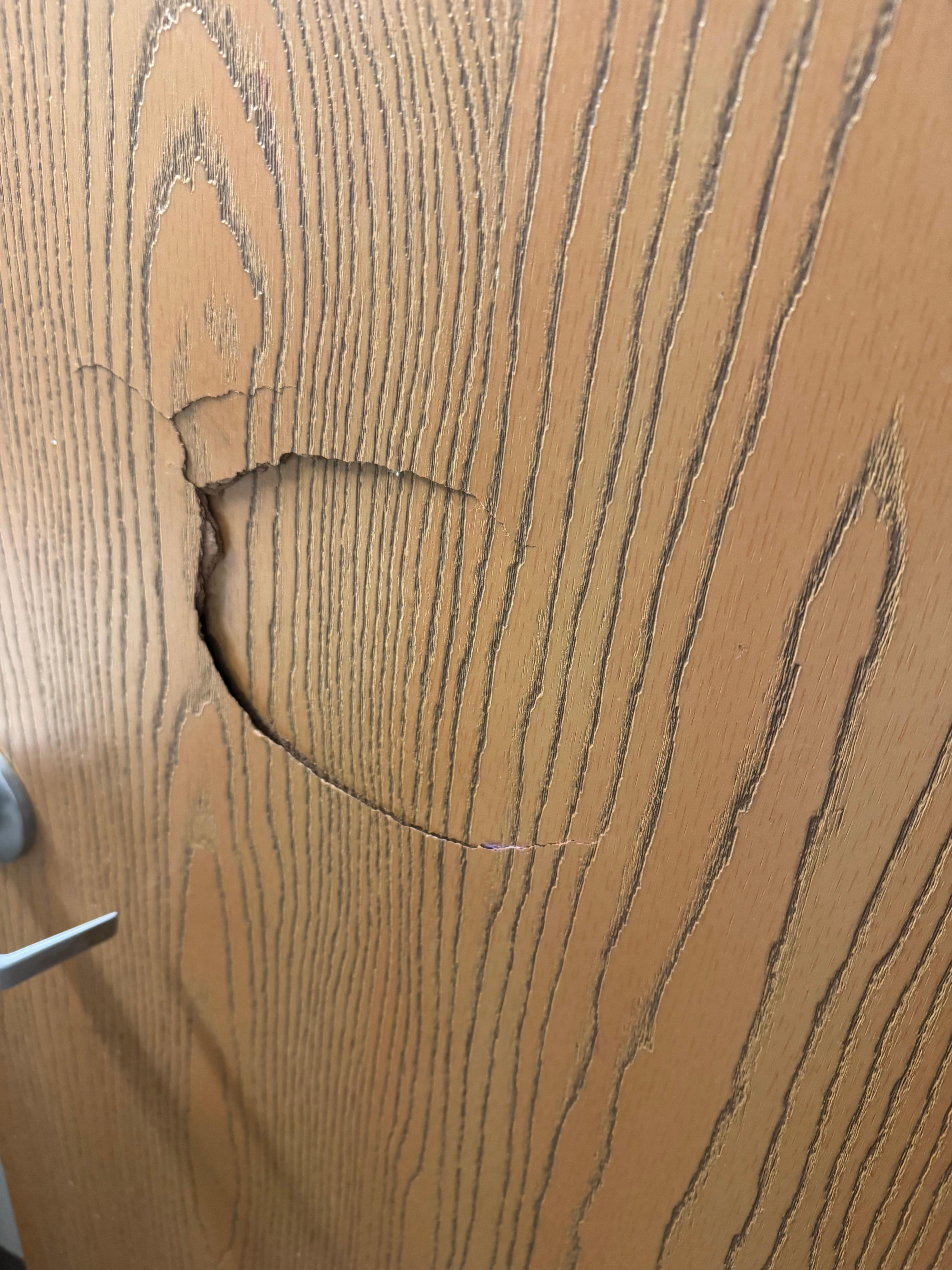 Hole punched in door