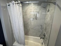 Photo shows bathtub / shower.