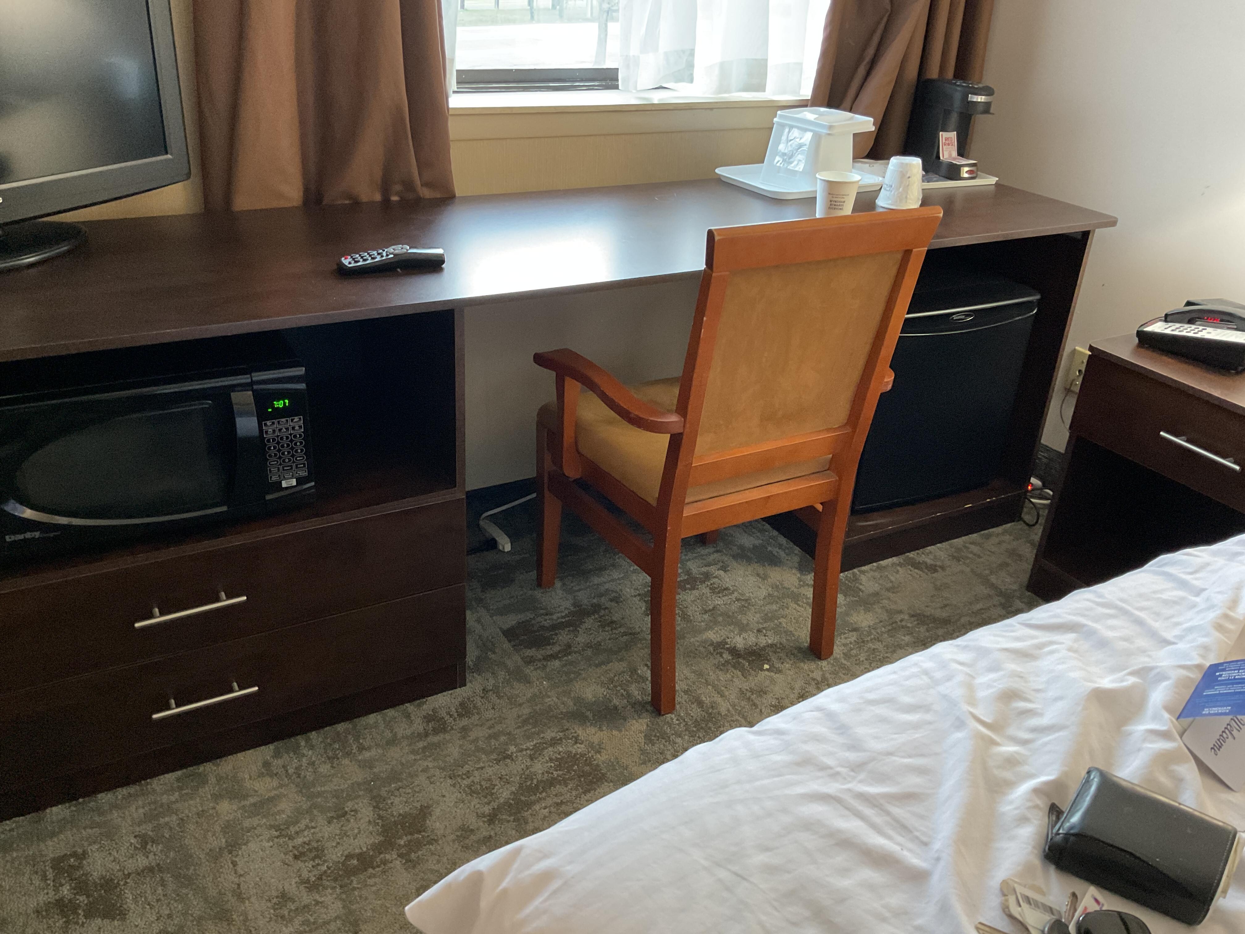 Under the desk and behind the chair is the air conditioner control 