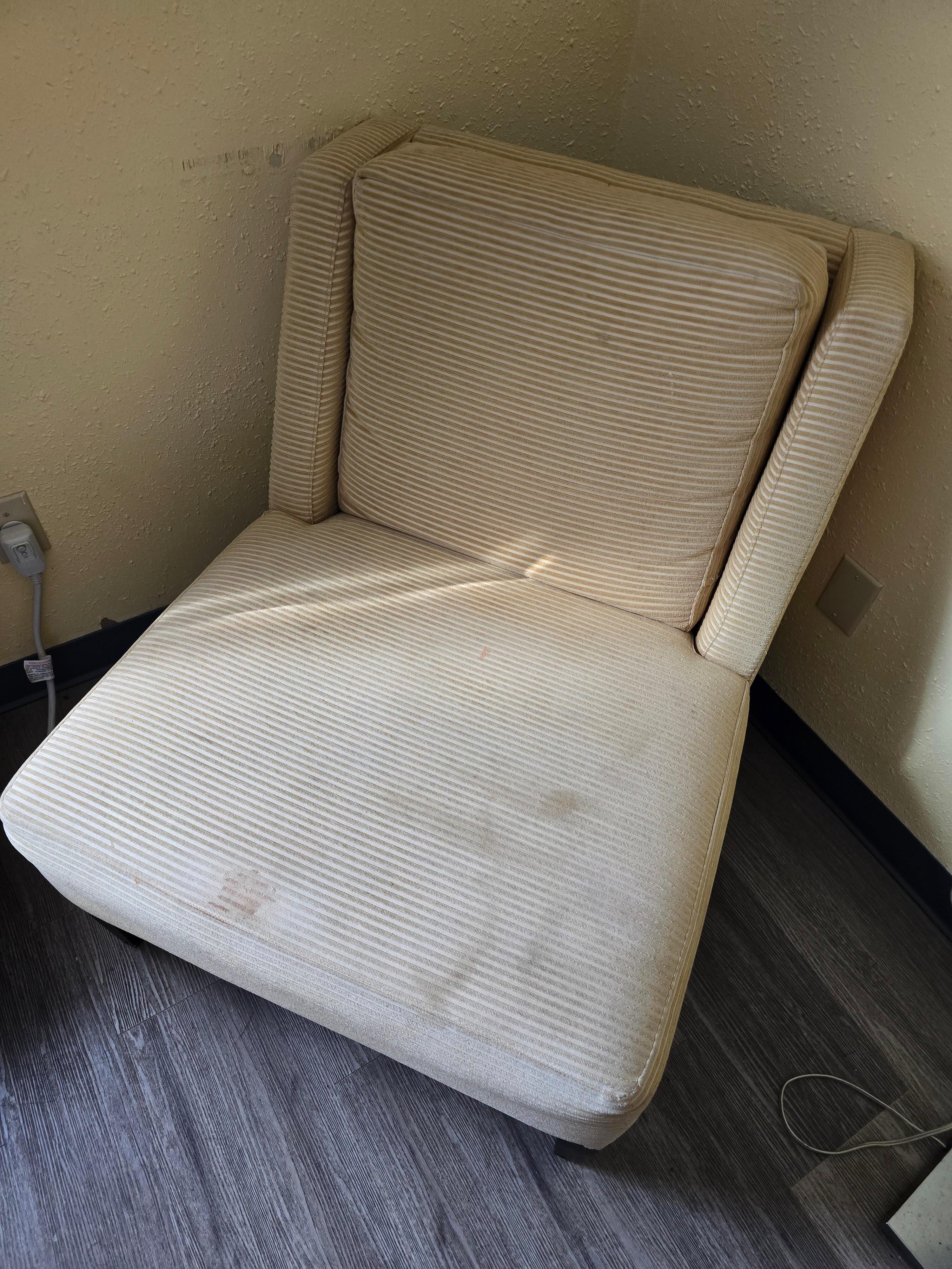 Stained chair in room.