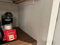 Liquids on the wall by coffee machine.