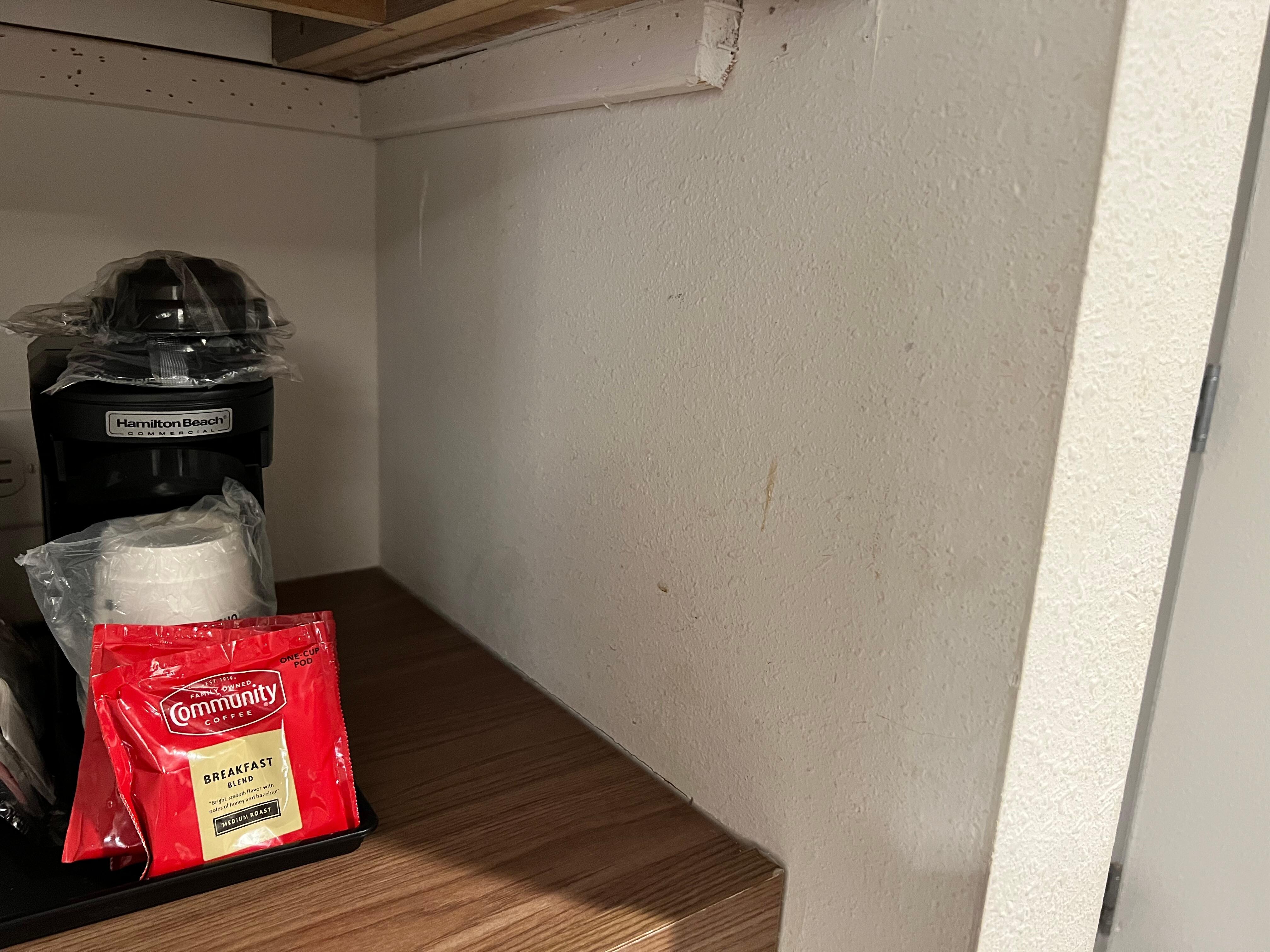 Liquids on the wall by coffee machine.