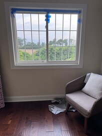Taped window with curtain on floor