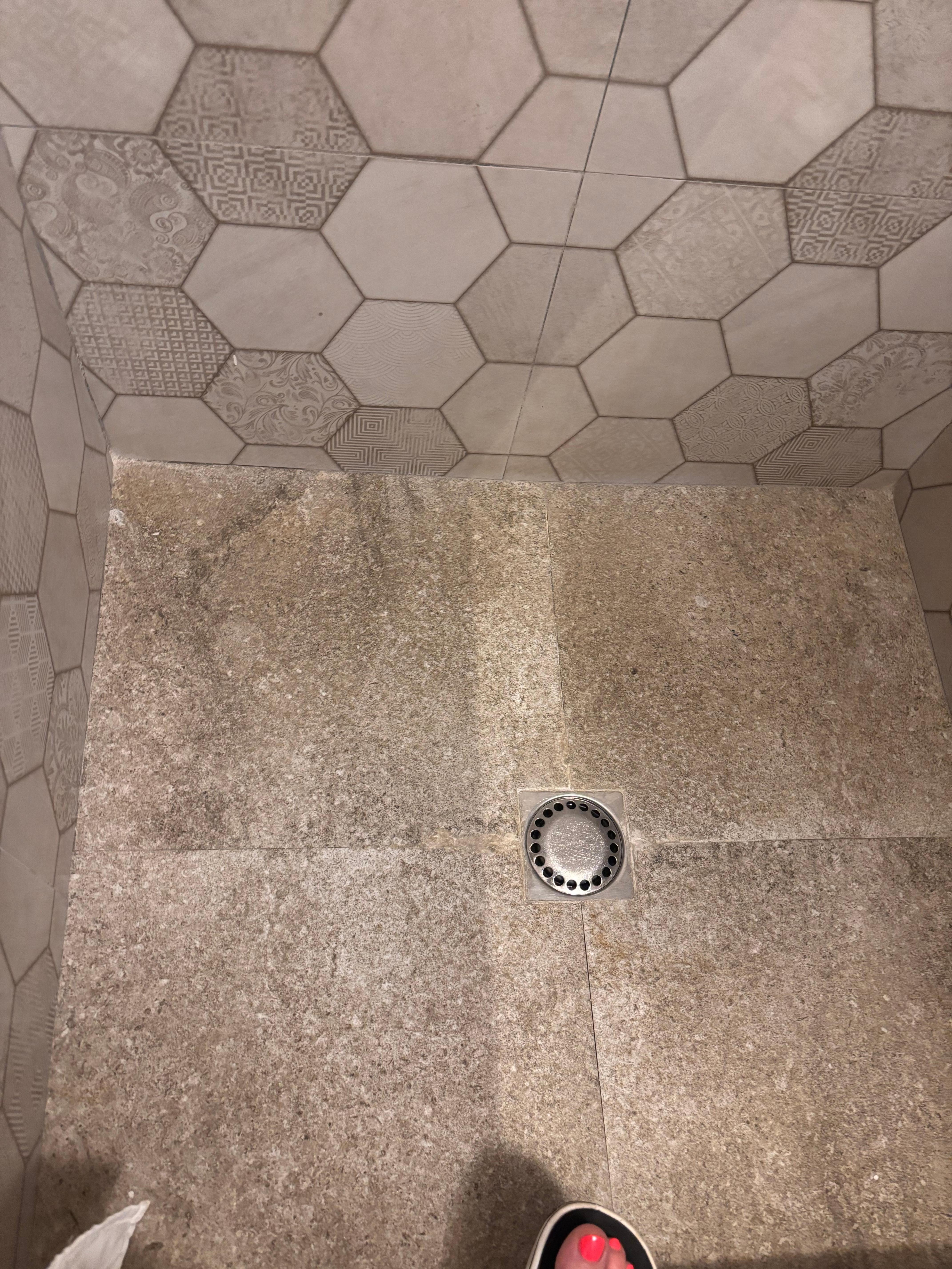 Shower floor has ground in dirt