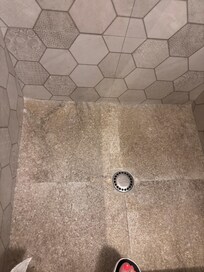 Shower floor has ground in dirt