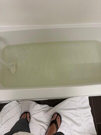 Room 120 has brown tub water and no stopper.