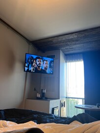 tv in front of bed in room