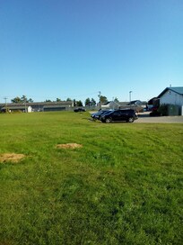Showing property behind this motel, the trees between the buildings the lake is on the other side