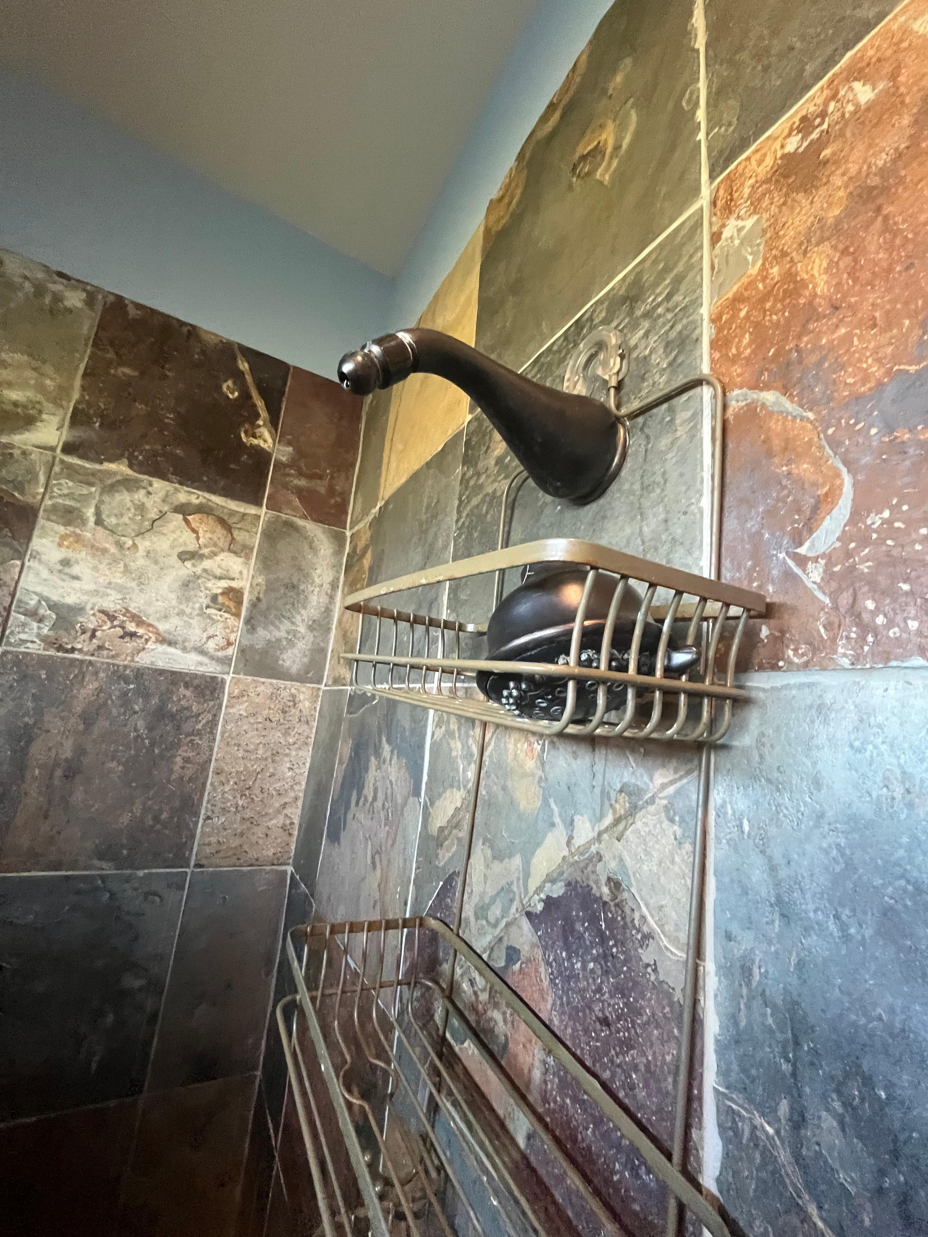 Missing shower head in master bath head that comes out of ceiling so covered in lime didn’t work either 