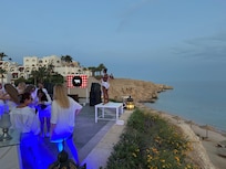 Night party. But notice the dancer in heel on the table next to the cliff. Is that safe?