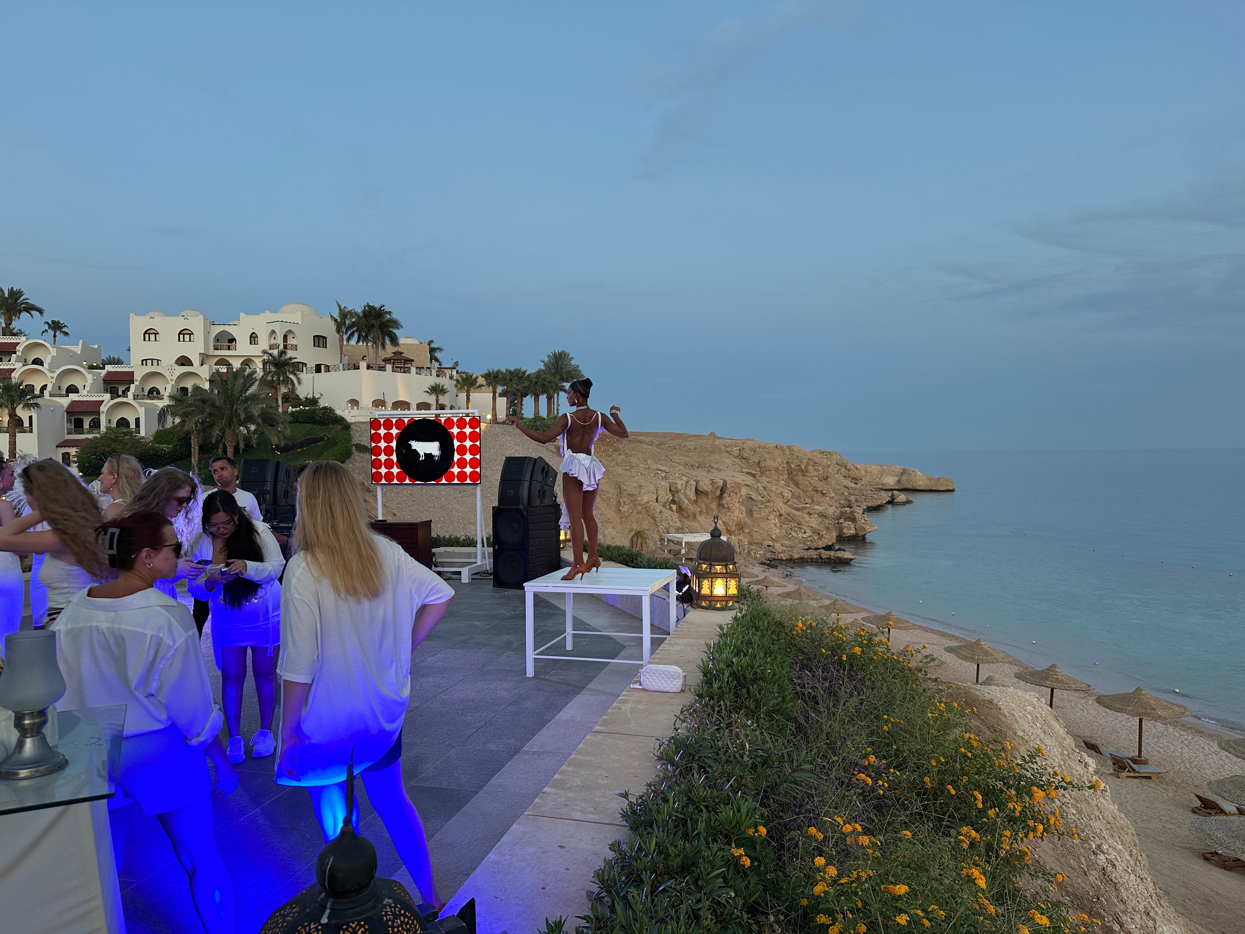 Night party. But notice the dancer in heel on the table next to the cliff. Is that safe?