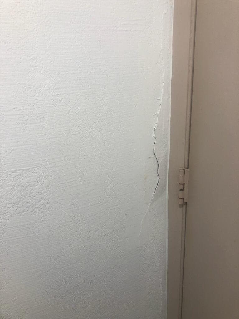 Cracks by bathroom door frame