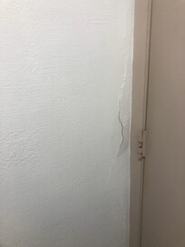 Cracks by bathroom door frame
