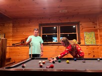 A game of pool with granddaughter and granddaddy