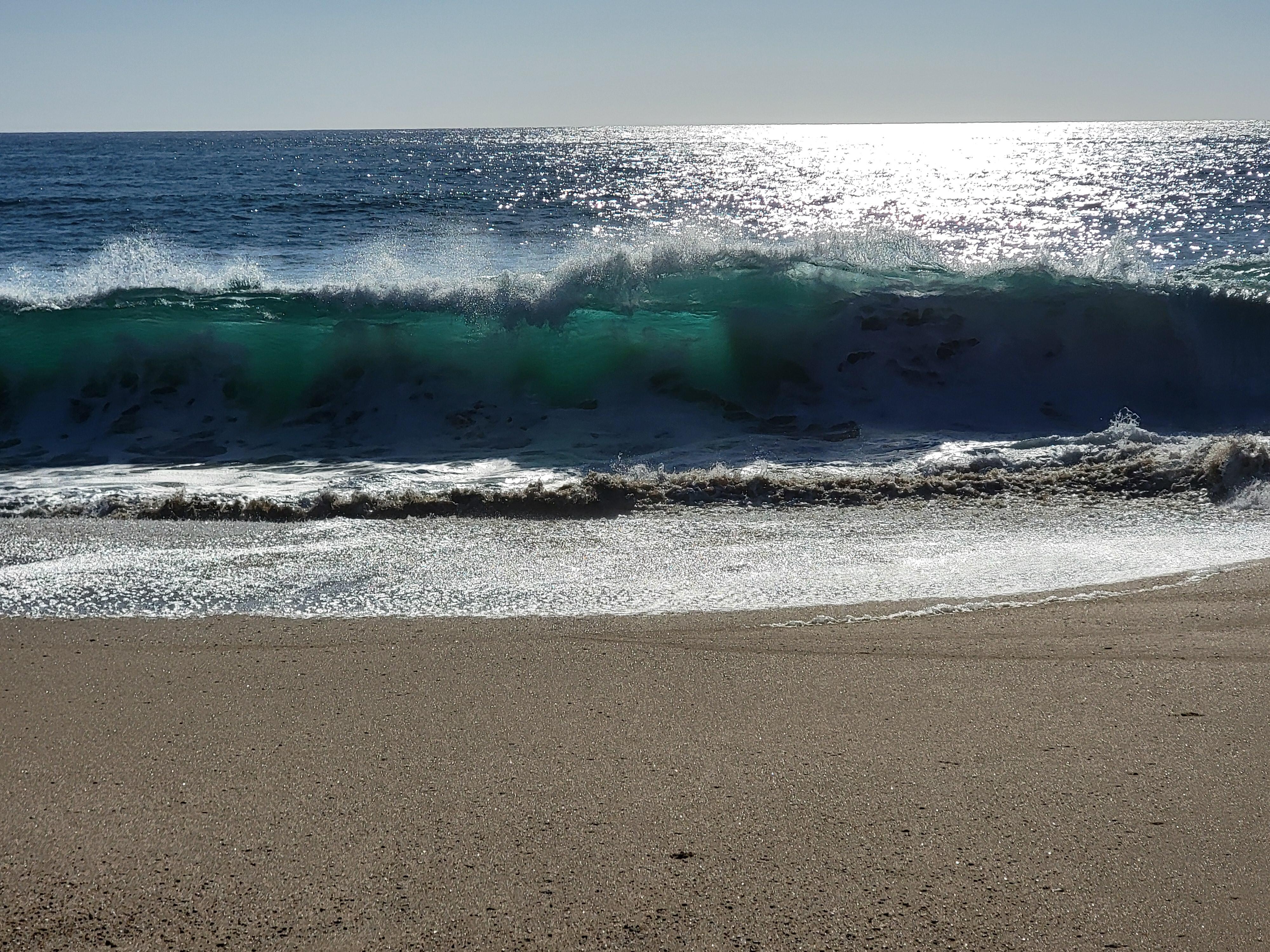 Beautiful blue water, waves. Shore breaks so not great for swimming this high.  Warm water!
