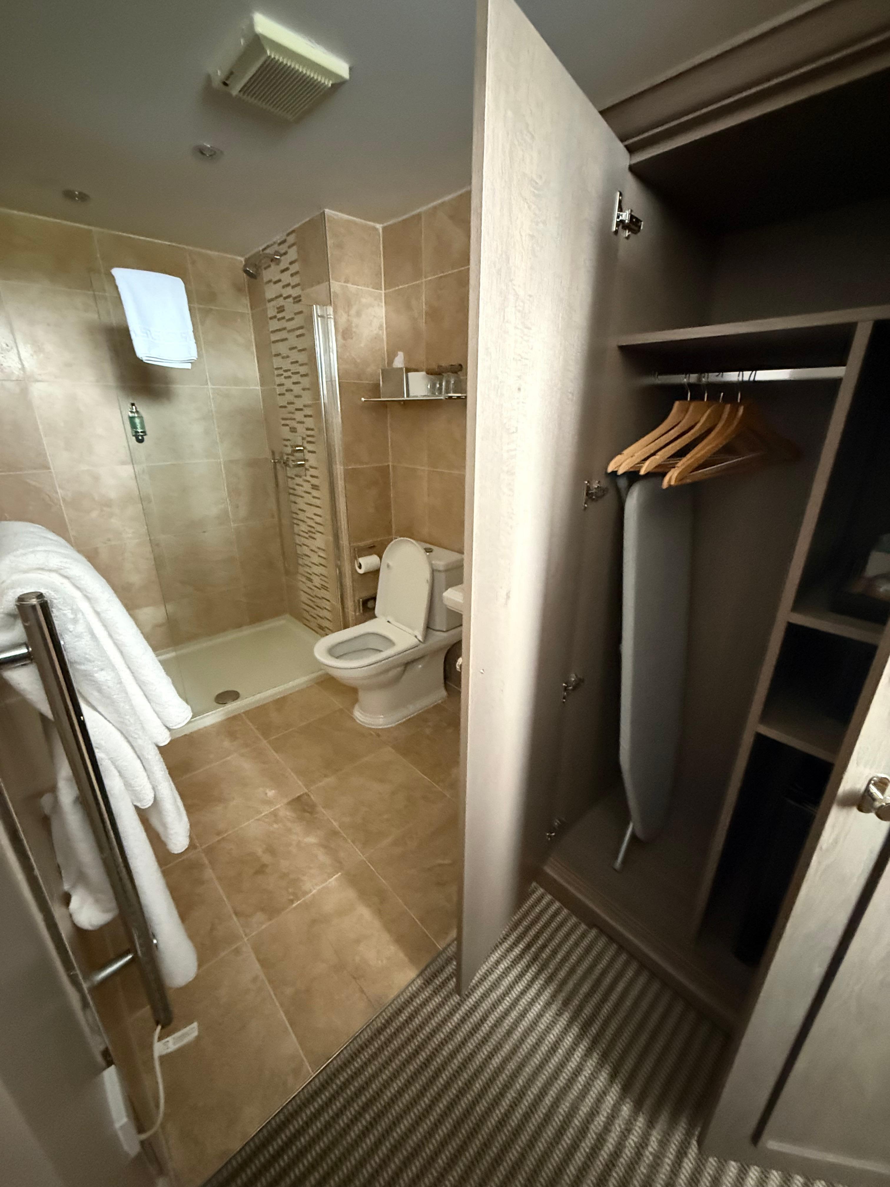 Good closet space with iron/board, mini fridge, & tea kettle. 