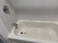 Tub damage and dirty tile.