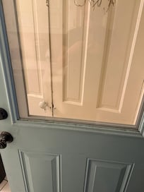 Garage entry door, dirt on the windowsill. No curb appeal. How about a welcome mat at the bottom?