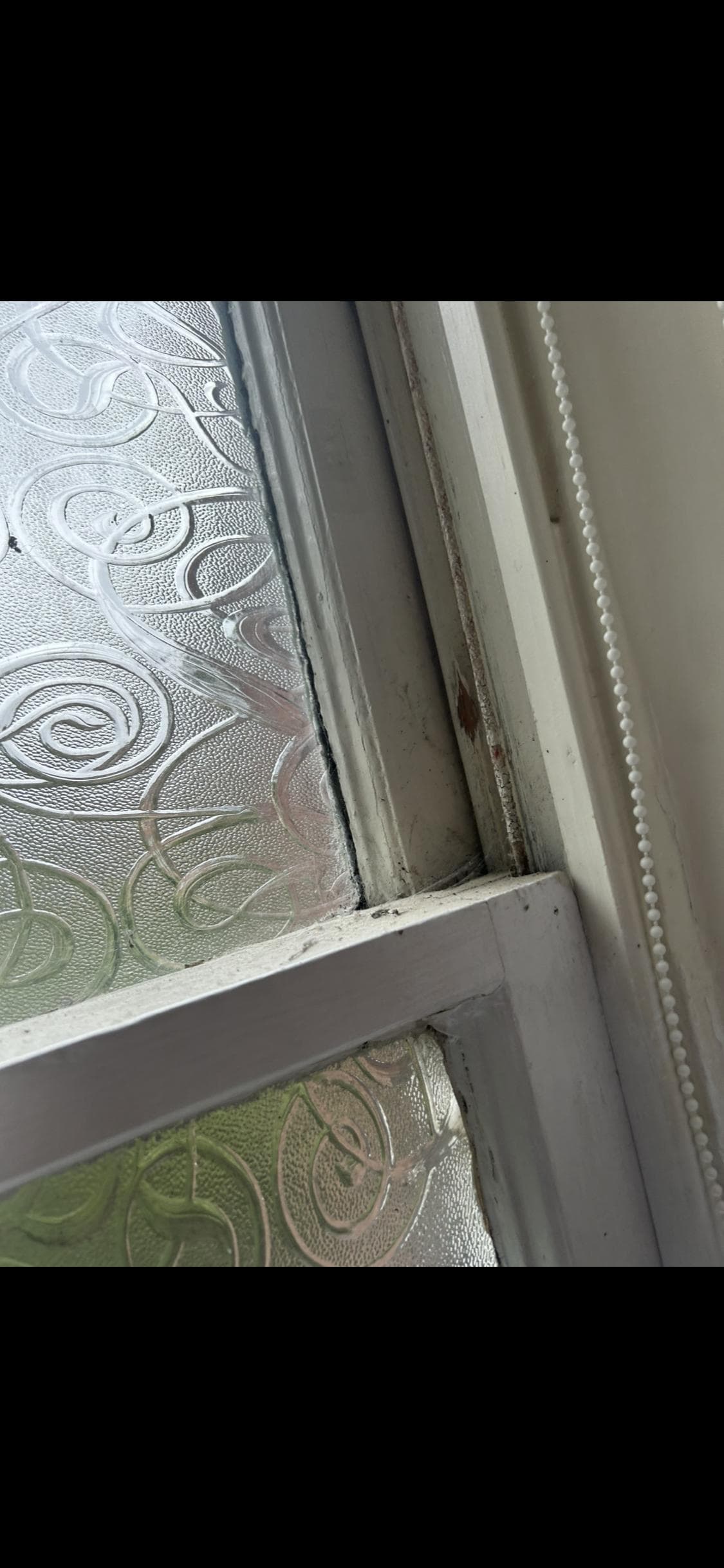 The window frame was covered in dirt and cobwebs 