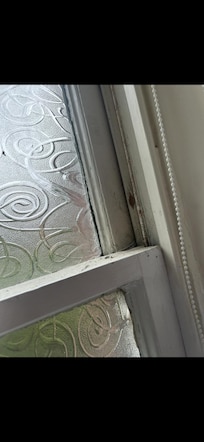 The window frame was covered in dirt and cobwebs