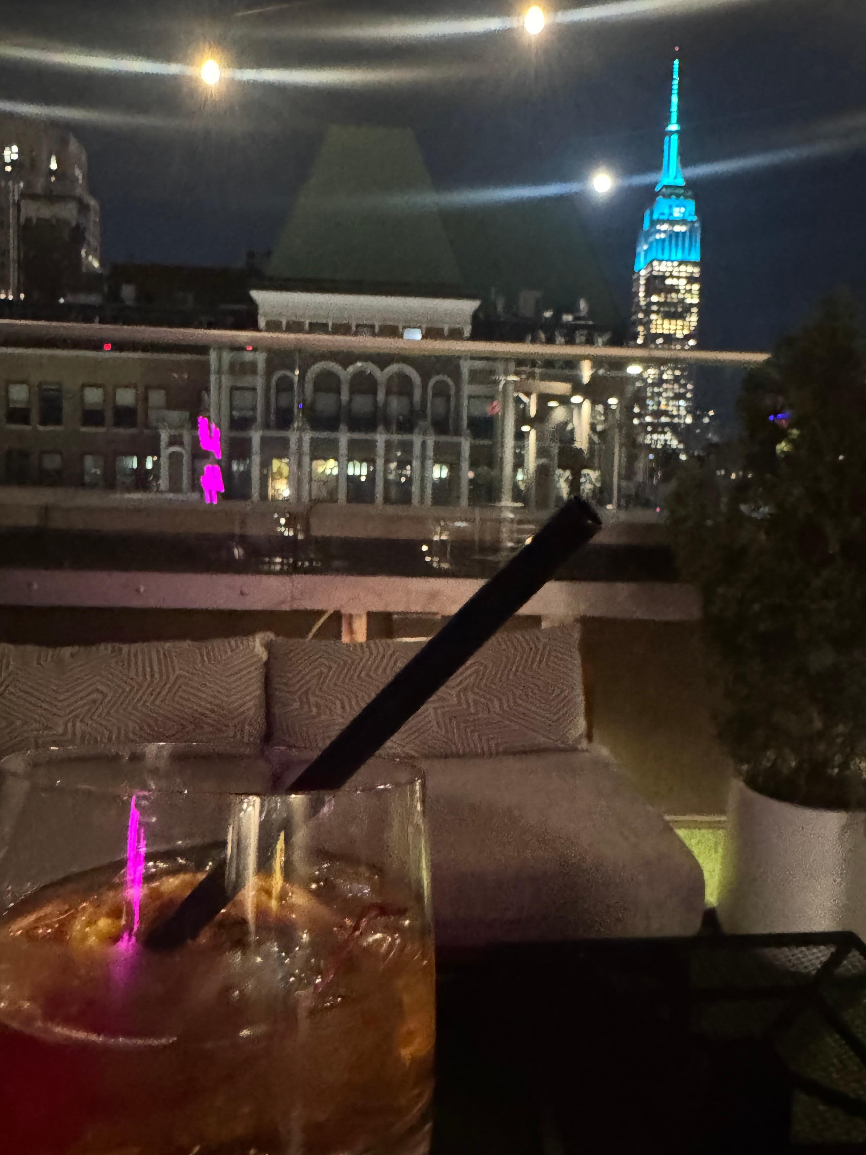 Rooftop bar view of Empire State Buildinf cocktail 