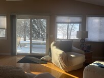 Sitting on the couch watching TV, looking out of the windows onto the lake