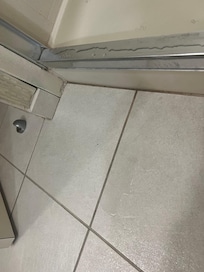 Water on floor after shower under the shower mat