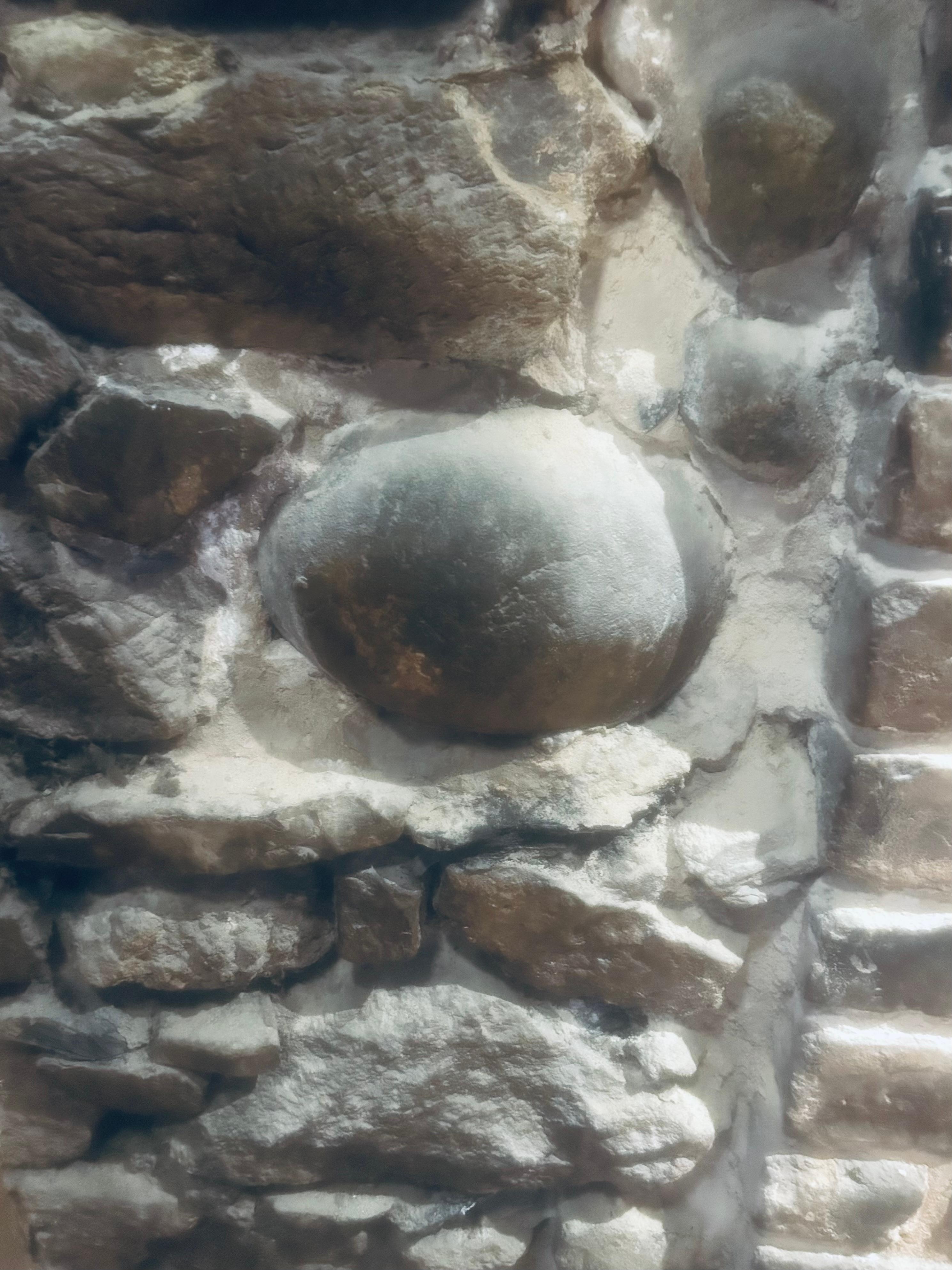 Cannonball lodged in the wall by Huey’s Restaurant