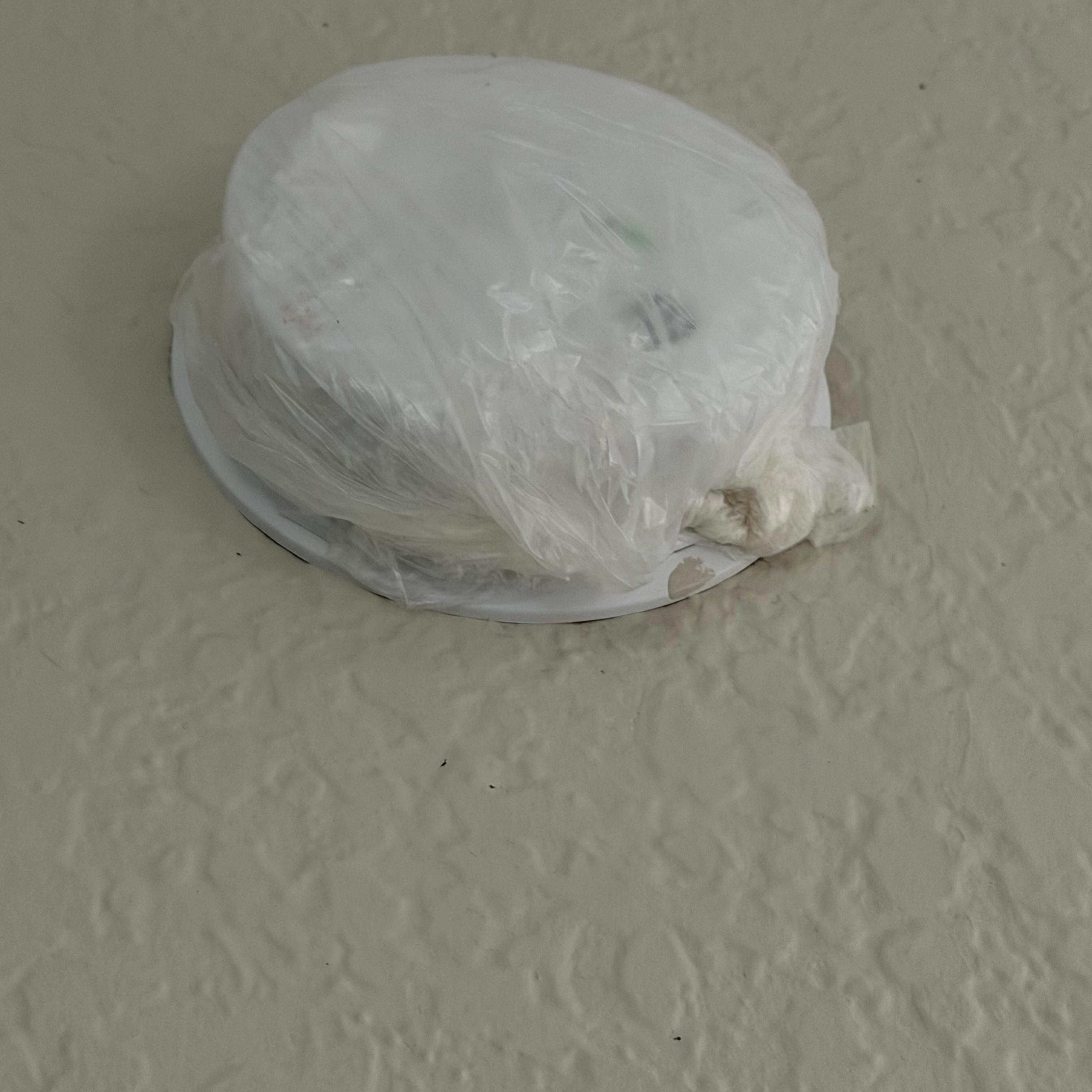 Smoke detector wrapped in a plastic bag, I don't know why.